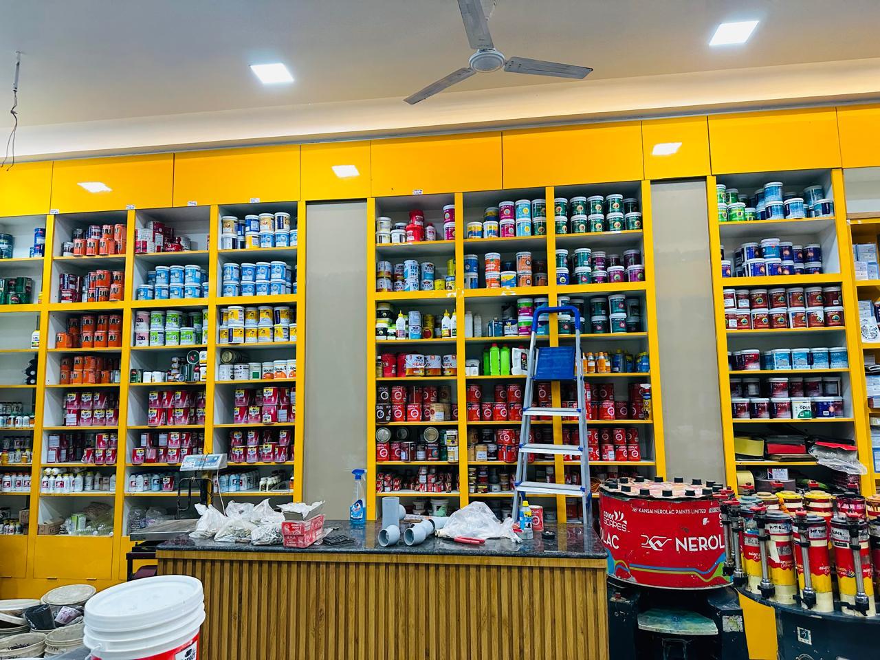 Inside the store — shelves stacked with paint cans and hardware supplies